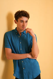 Man wearing a blue shirt against a yellow background